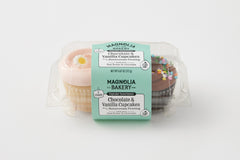 vanilla cupcake with pink buttercream topped with a daisy decon and chocolate cupcake with chocolate buttercream topped with confetti sprinkles in a clear plastic package.
