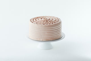 9 inch strawberry cake on a cake stand