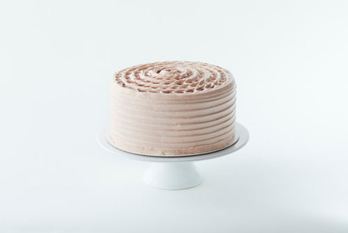 9 inch strawberry cake on a cake stand